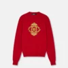 Sweter z haftowanym motywem architektonicznego baroku